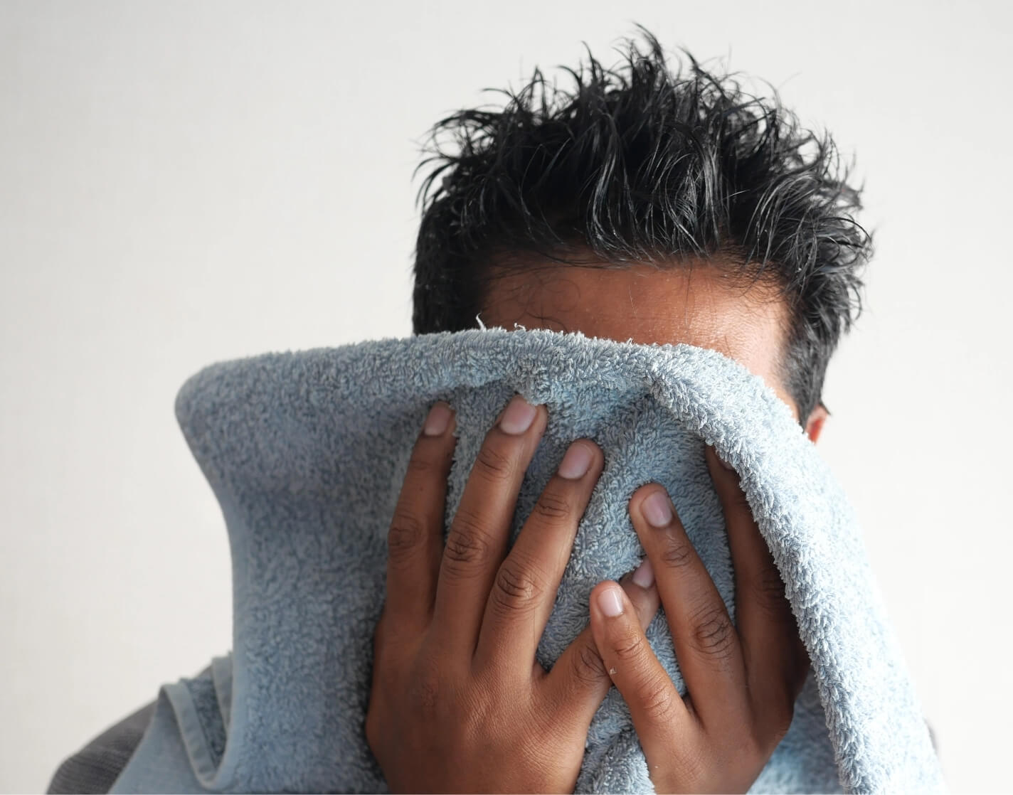 young-man-drying-his-face-2023-12-30-00-48-58-utc@2x
